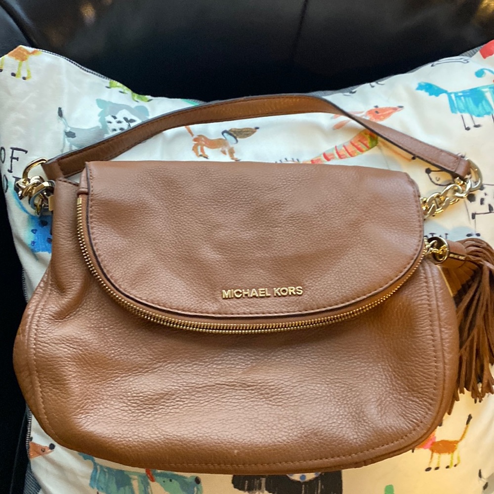 Brown Michael Kors leather purse. Places to store stuff everywhere!